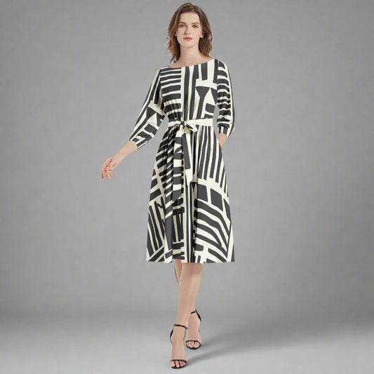 Front view of the Black & White Geometrical Tribal Print Belted Dress showcasing its striking print.