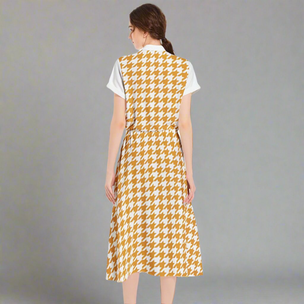 Close-up of the houndstooth pattern in yellow and pink on the dress fabric, highlighting its bold colors.