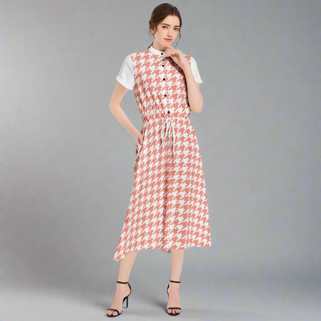 Side profile of a Houndstooth Yellow and Pink Midi Dress, showcasing the flared skirt and fitted waist.