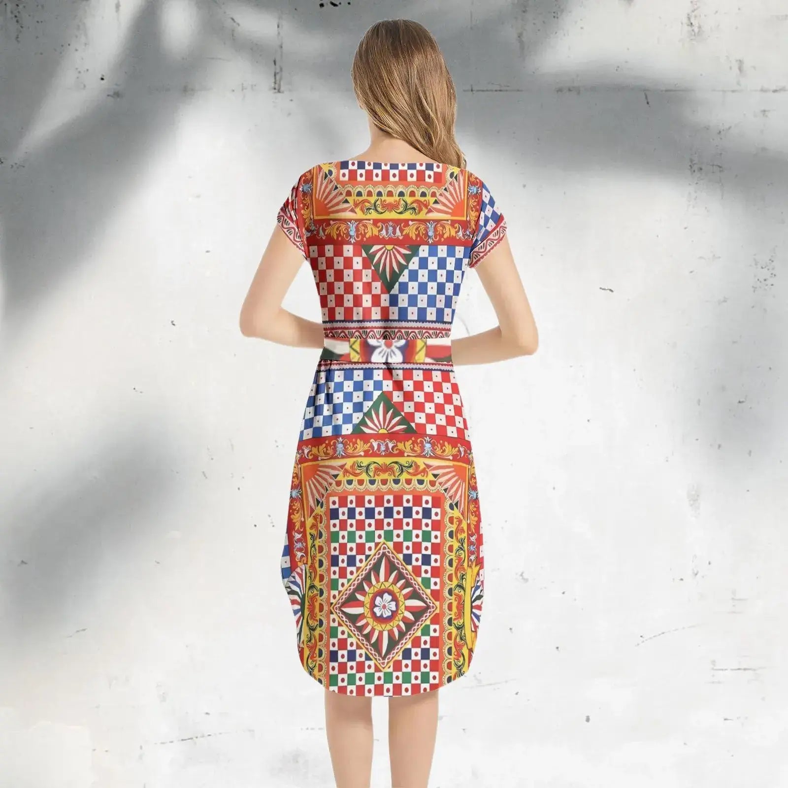 Side profile of an Italian Sicily Dress with a flowing skirt, showcasing elegant draping and bold colors.