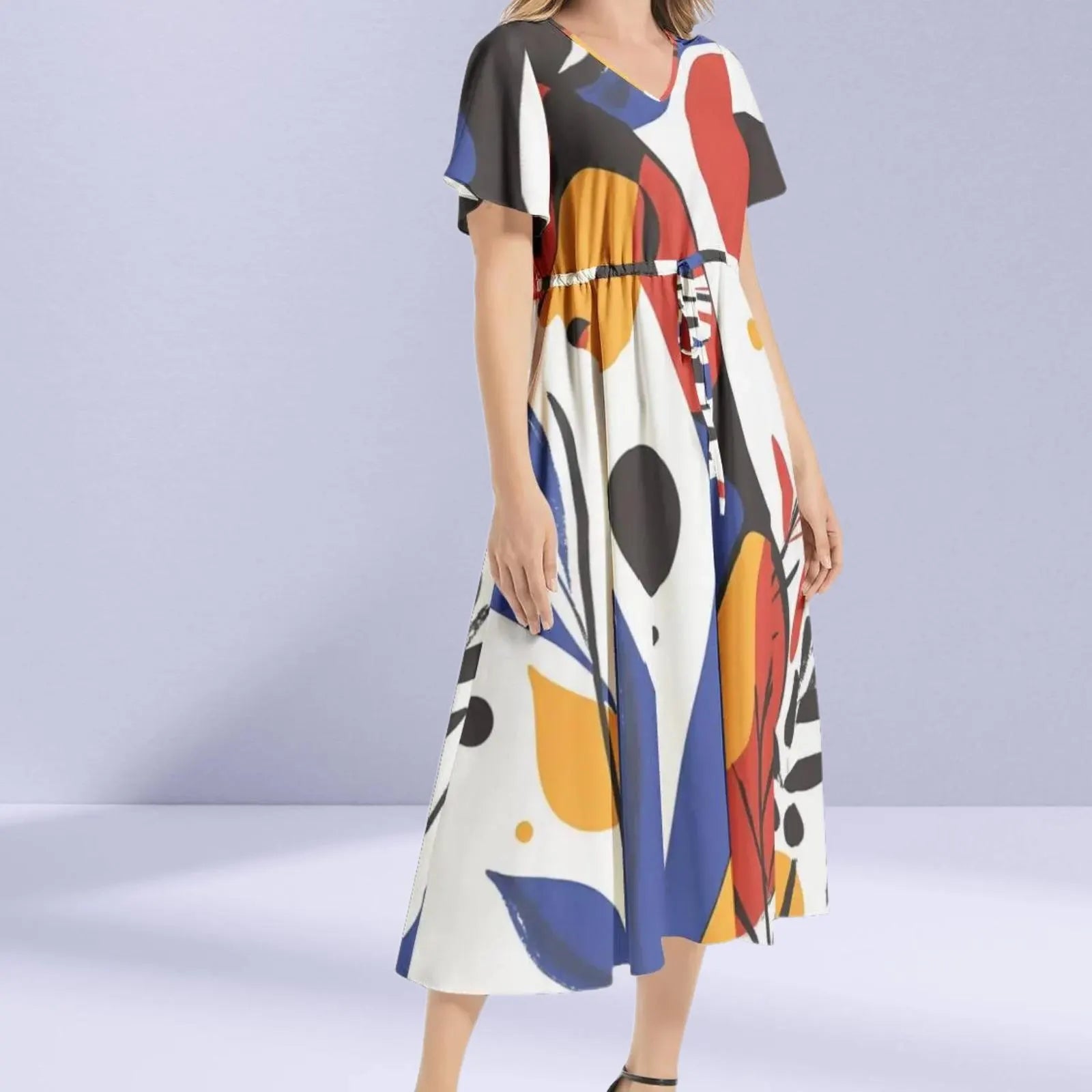 Close-up of the abstract patterns on the Joan Miró Maxi Dress, featuring whimsical shapes and primary colors.