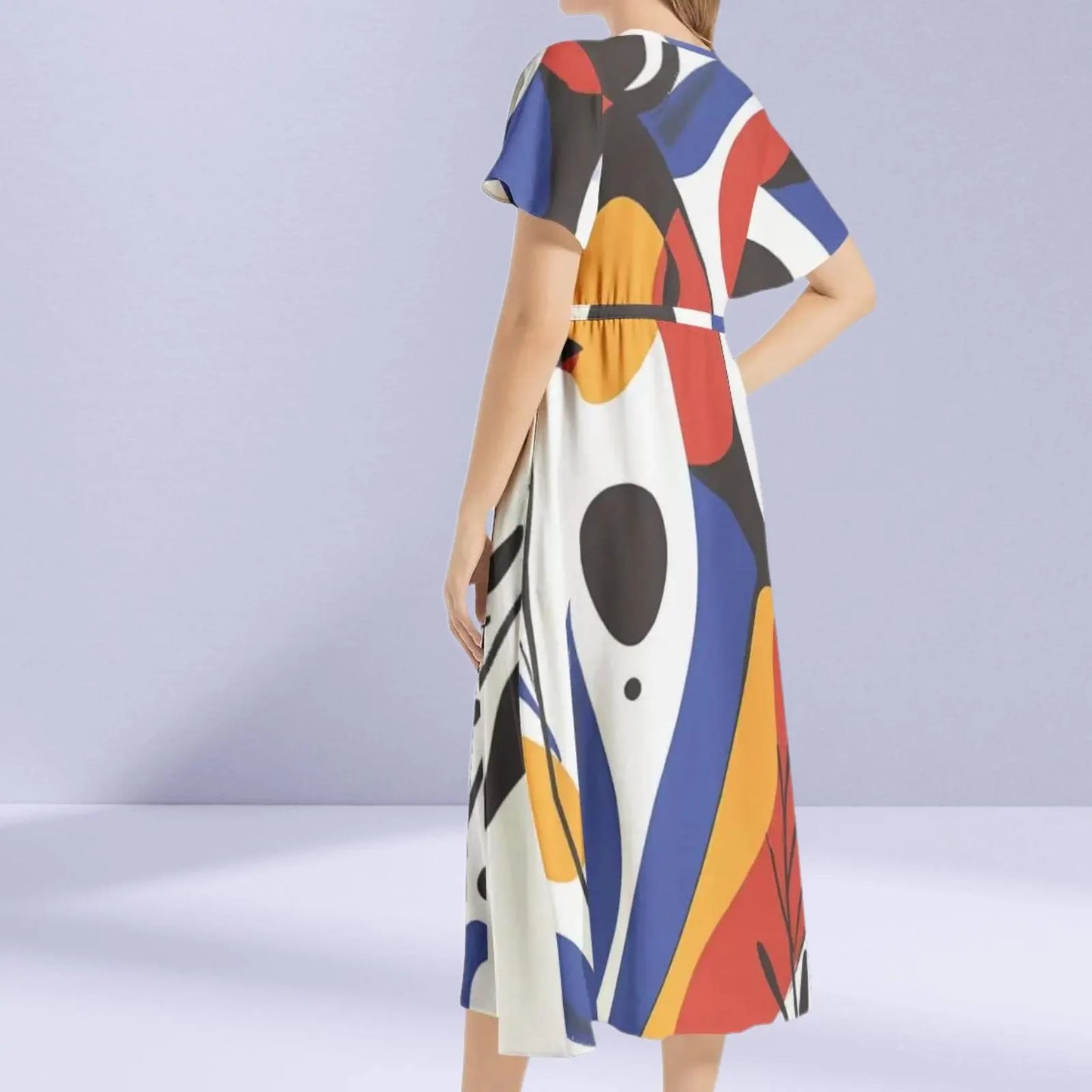 Side profile of the Joan Miró Maxi Dress, showcasing the flowing silhouette and unique abstract print.