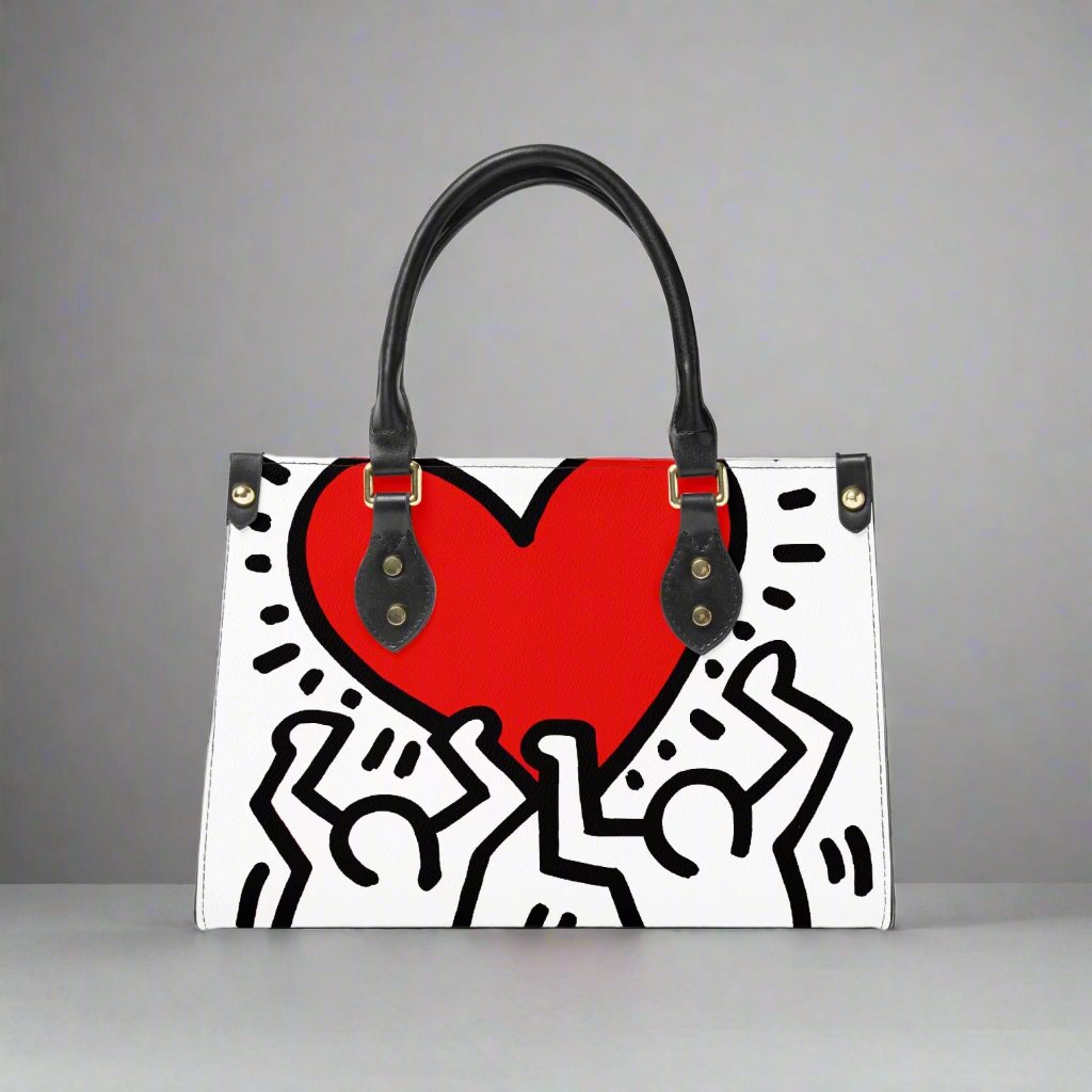 Front view of the Keith Haring 'Love' Vegan Leather Small Tote Bag, featuring bold heart and figure designs in red and black