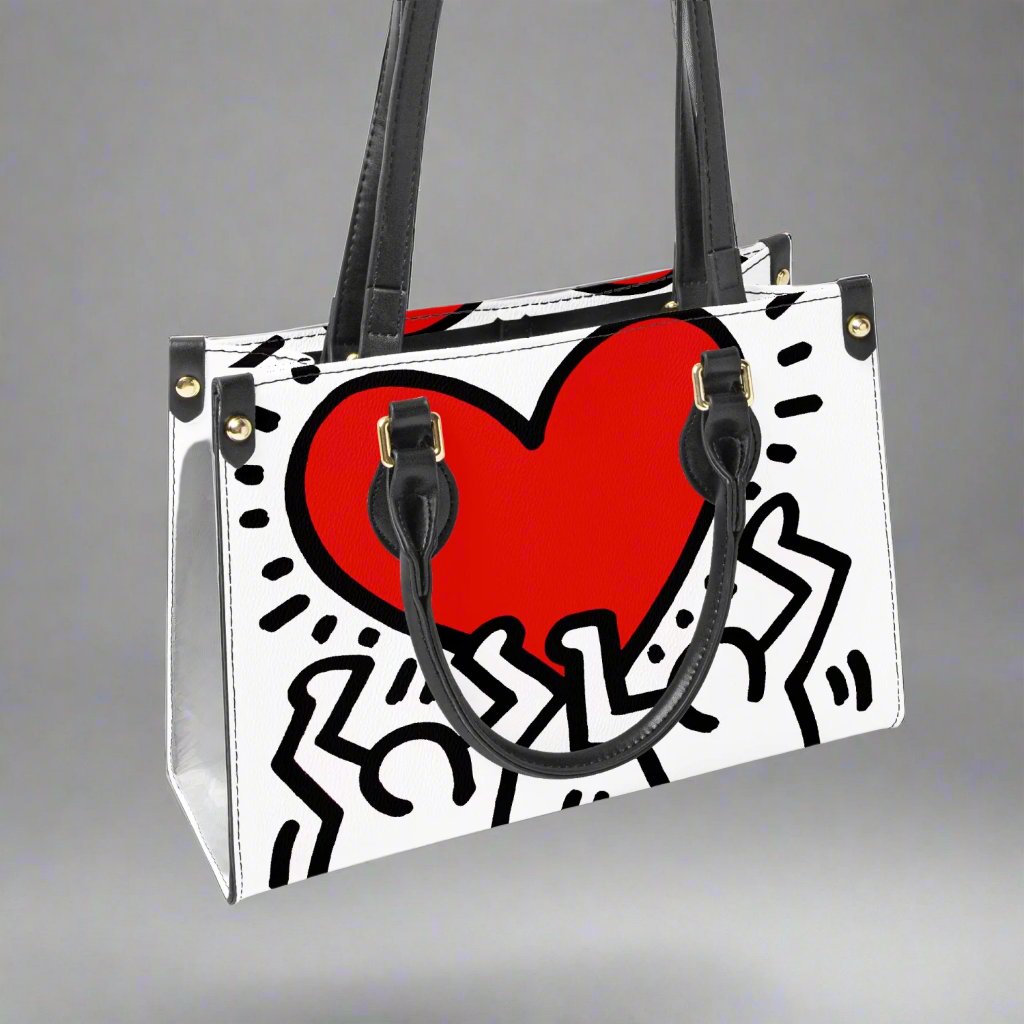 Model carrying the Keith Haring 'Love' Small Tote Bag styled with casual attire for an artistic, chic look