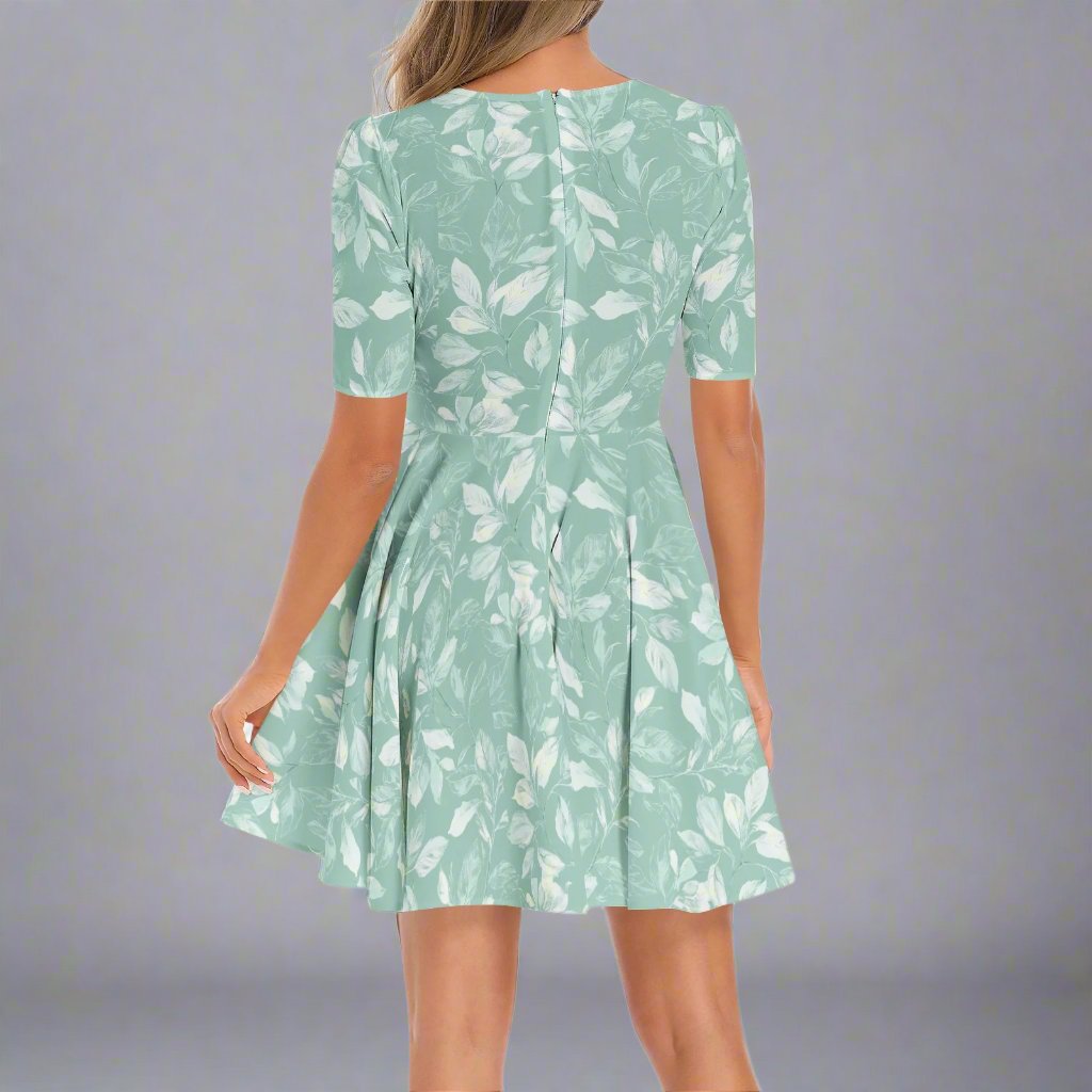 Close-up of the Sage Green Floral Flared Hem Dress's fabric, highlighting the floral details