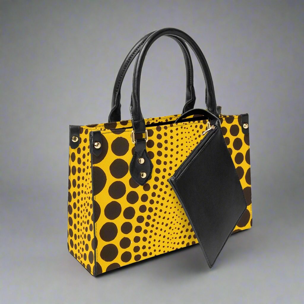 Side profile of the Yayoi Kusama Yellow Dot Tote Bag, emphasizing its spacious design.