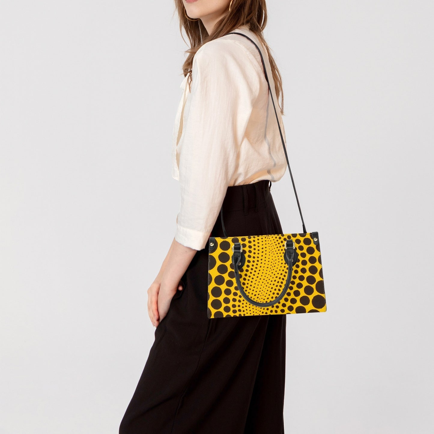 Yayoi Kusama Yellow Dot Tote Bag styled with accessories for a trendy look